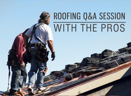 two workmen walking on roof of building