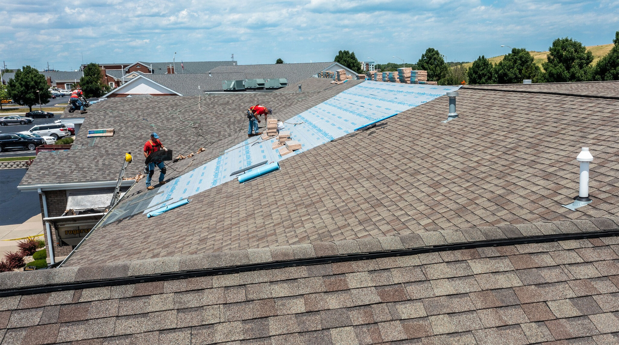 Old asphalt shingles being removed during a residential roof replacement project.