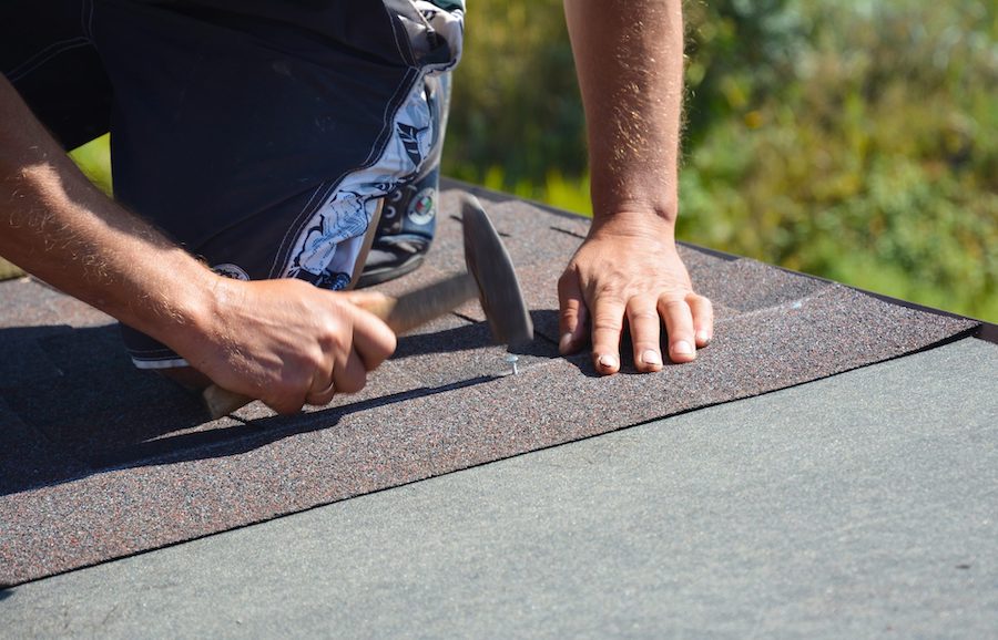 Roofing crew installing new architectural asphalt shingles on a residential home in the Chicagoland area.
